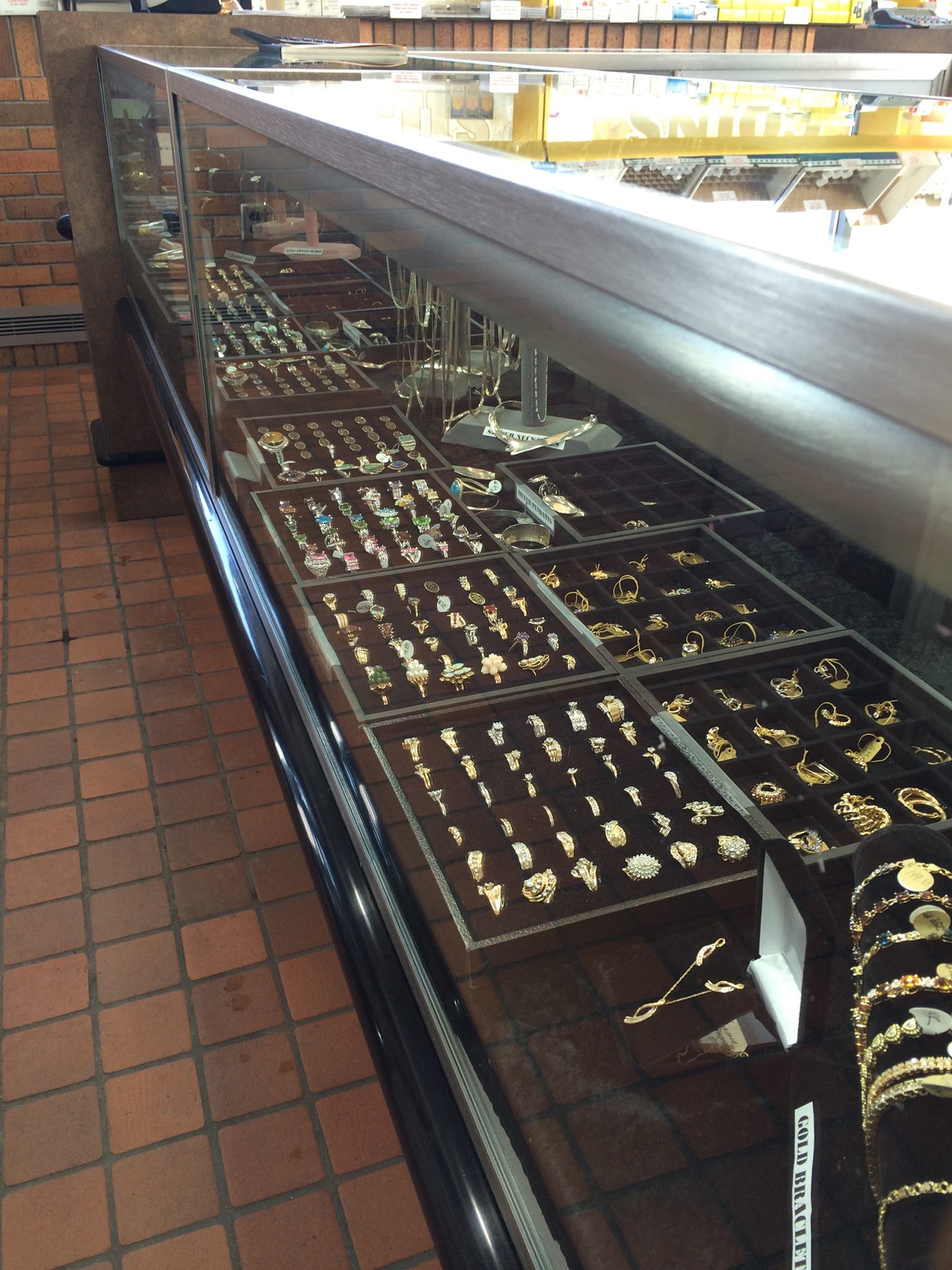 Gold and silver jewelry shown in store display case