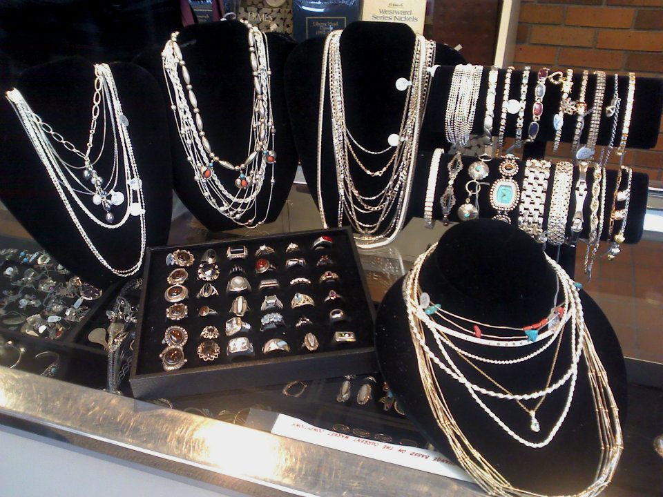 Gold and silver jewelry on top of display case