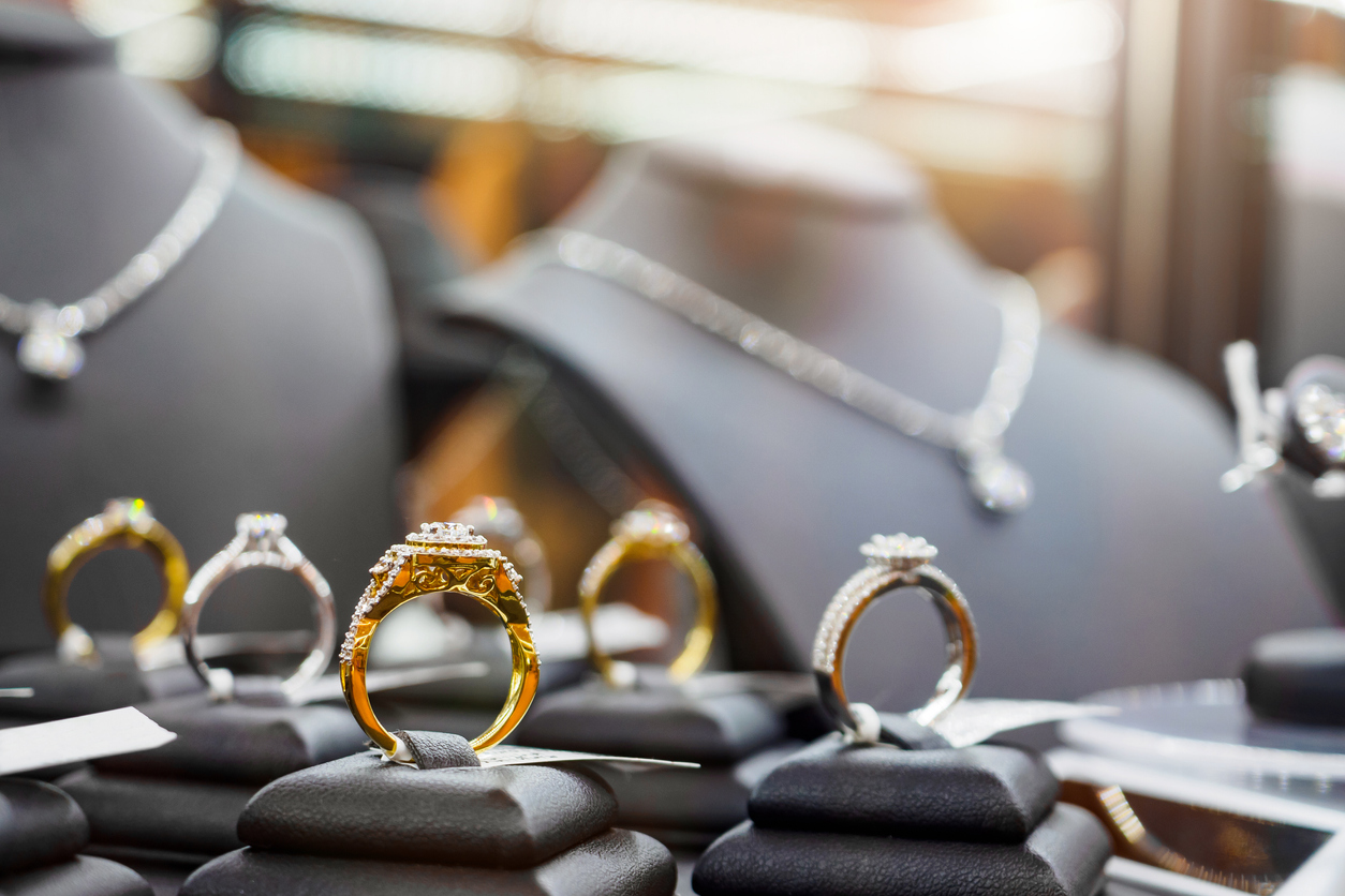 Gold jewelry diamond rings show in luxury store window display showcase