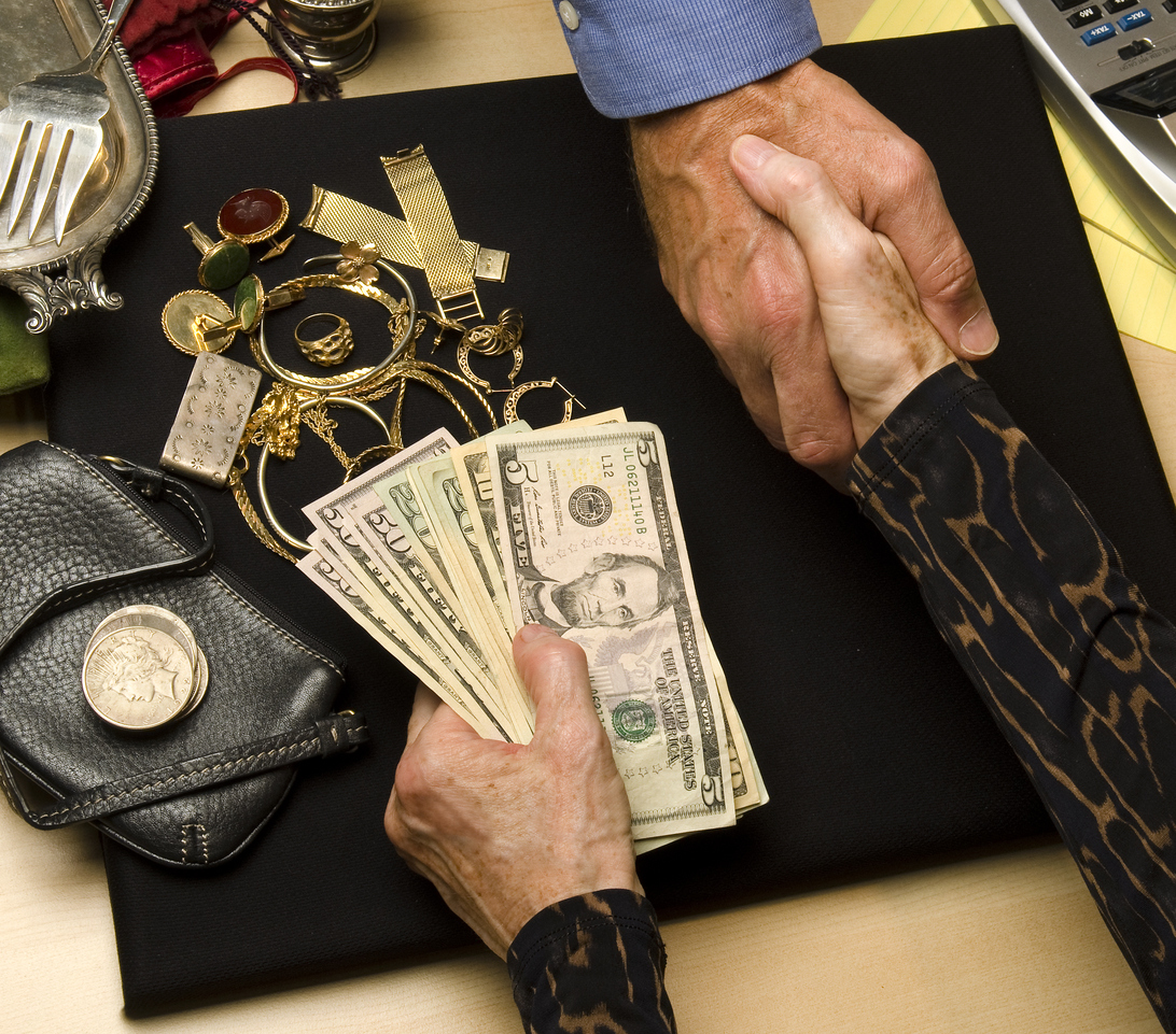 woman receiving cash for gold and silver items